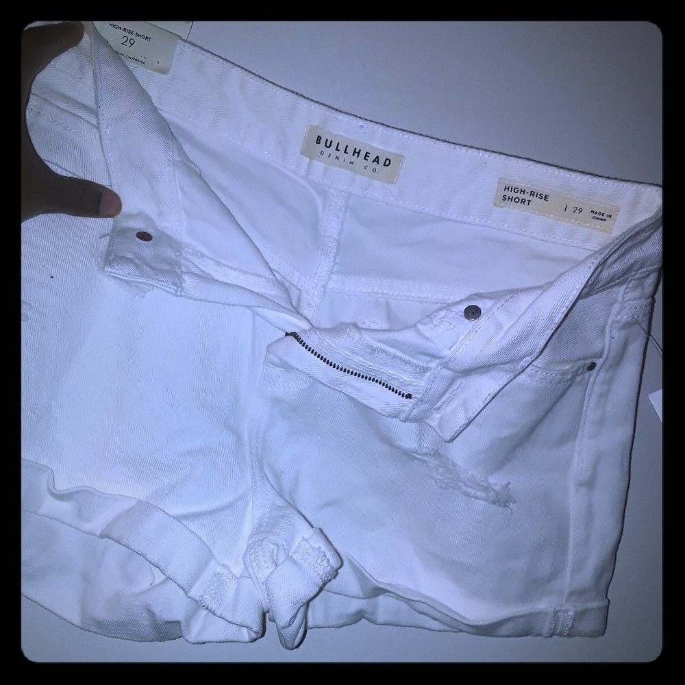 White ripped shorts